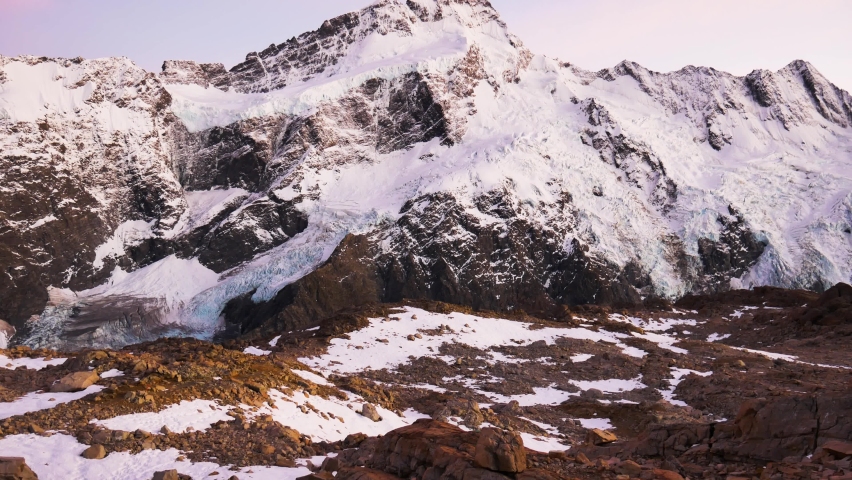 Panorama shot of spectacular mountains range covered with snow during sunny day - Mueller Hut Route,New Zealand