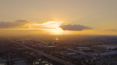Munich aerial skyline view froma bove birds view from above at sunset, munich germany dramatic clouds drone video in 4k.