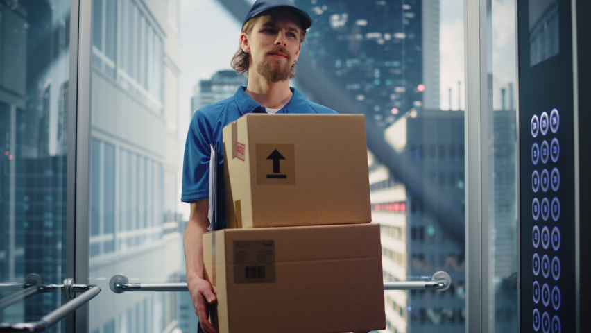 Young Delivery Person Riding Glass Elevator in Modern Office Building. Mail Courier Holding Cardboard Parcel Boxes. Handsome Mailman Delivering Fragile Packages in Business Center Lift. | Shutterstock HD Video #1084312561