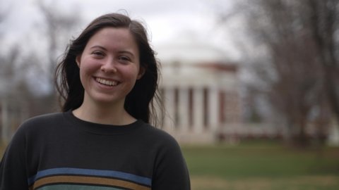 Portrait of a young teen female student at a university or college in Charlottesville, VA in front of the rotunda designed by Thomas Jefferson.