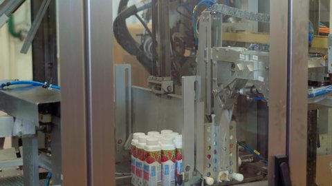 Lots Of Yoghurt Bottles Move On Conveyor, Get Divided By Conveyor Machine And Placed The Other Way. Automated Sorting. Modern Equipment At Dairy Based Products Manufacturing Factory. Food Industry
