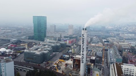 Zurich, Switzerland - December 14 2021: Aerial drone footage of the  Industriequartier in Zurich with the Chimney of forwer waste incineration plant on a cloudy winter day in Switzerland.