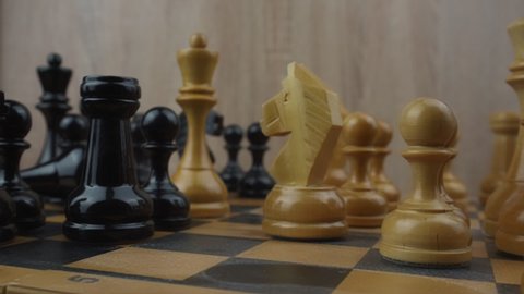Overthrowed black king chess piece lying down on chessboard. Business target and marketing strategy concept.