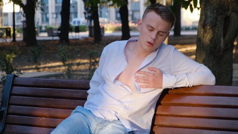 Heart attack and shortness of breath in a young man on a park bench
