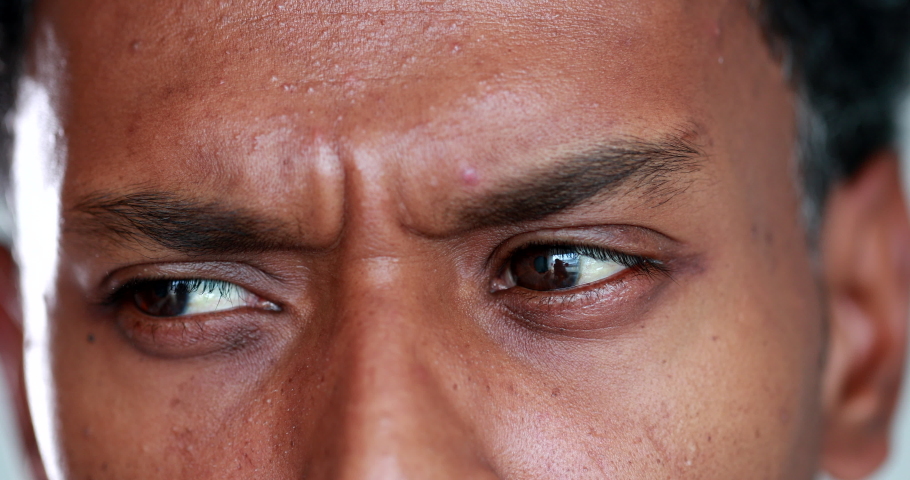 Thoughtful person thinking, macro close-up eyes looking sideways pondering, looking for solution