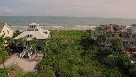 Luxury homes in a coastal neighborhood by a sandy beach
