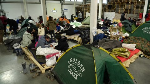 Grodno, Belarus, December, 3, 2021. Migrant camp at the Polish-Belarus boarder. Inside and outside the camp. Daily routines