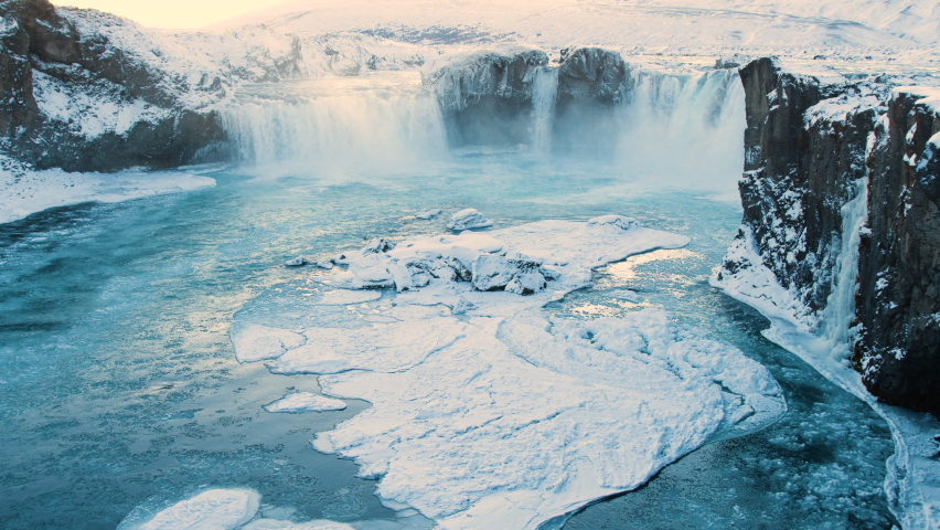 Godafoss, famous waterfall in Iceland, Frozen waterfall in winter, a magical winter location of snow and ice, Pure glacial water with a huge current Royalty-Free Stock Footage #1084336261