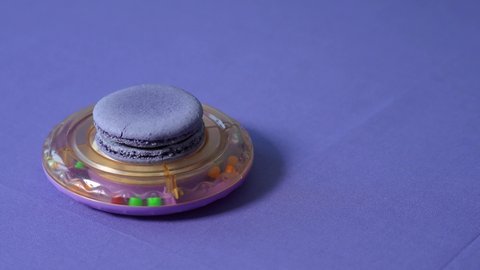 Simulation of an unidentified flying object. Baby rattle in trendy colors. 4K Very Peri. Barvinok. Color of the year 2022 concept. Macaroon almond. Shades lilac, purple, lavender. Inspired by 17-3938