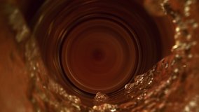 Fresh beer pours into a glass creating golden yellow splashes and swirls. Top-down macro super slow motion studio shot with copy space and selective focus. Alcoholic refreshment beverage and no people - Powered by Shutterstock - Get 15% off with code: PIKWIZARD15
