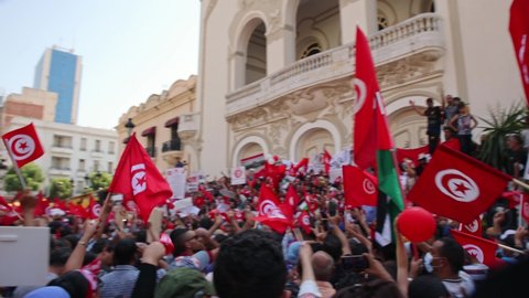 Tunis , Tunisia - 10 23 2021: Thousands Of People In The Street Waving Tunisian Flag During Protest In Tunis City