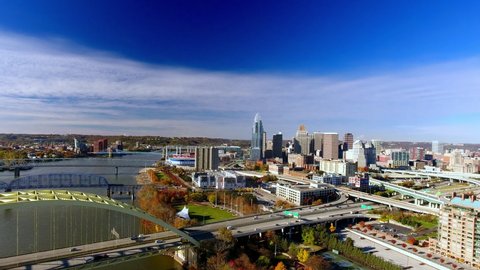 Rising drone footage of downtown Cincinnati Ohio with busy traffic on the highway
