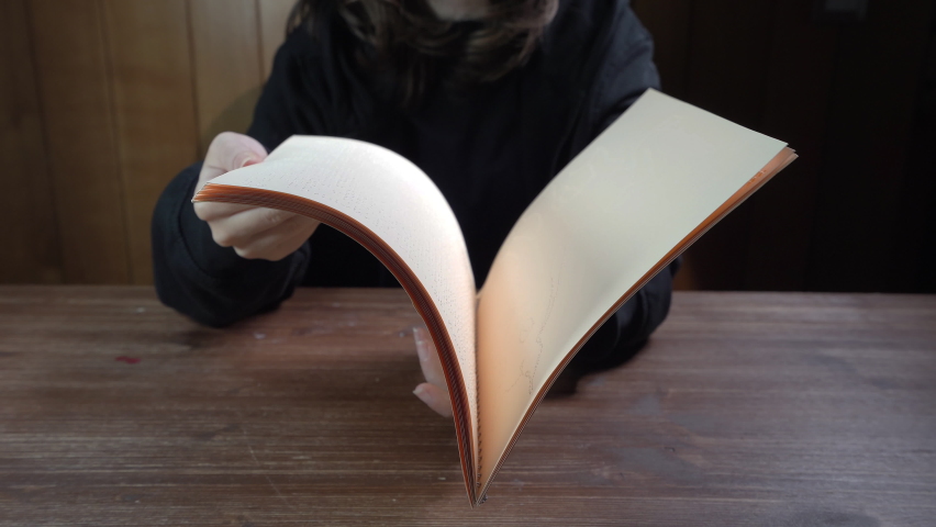 United Nations international day of the Braille language. The girl who leafs through a book written in Braille language	