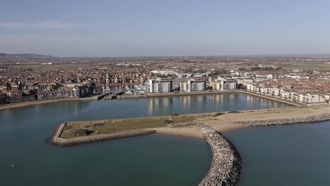 Aerial footage of Sovereign harbour in Eastbourne along the entrance and the start of Pevensey bay.