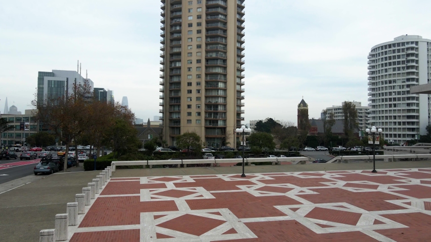 Aerial drone view rising in front of a apartment building, in cloudy San Francisco, USA