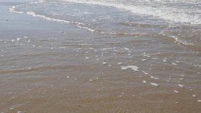 Waves on sandy beach slow spreading in slow motion 1080p FullHD footage - Slow-mo of dreamy beach scene 1920X1080 HD video