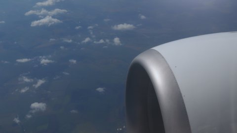 Beautiful sky and jet engine view outside the window of commercial airplane while floating on the atmosphere sky to destination. View of blue sky with cloudy. Aerospace and Transport Industry concept.