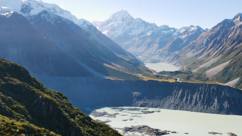 Panorama shot of epic Tasman and Mueller Lake during beautiful sunny day - Snowy peak of Mount Cook in background