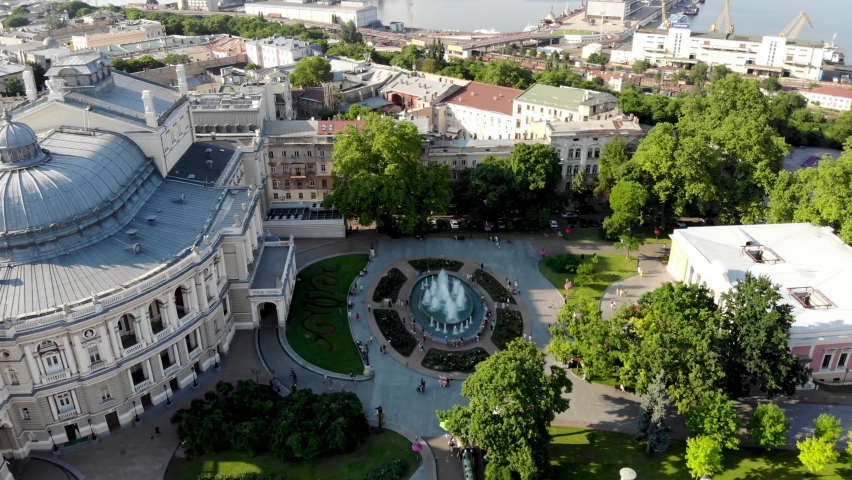 View from the drone Odessa National Academic Opera and Ballet Theater. One of the largest theaters in Ukraine. People are resting near the fountain of the Odessa Opera and Ballet Theater. Odessa drone