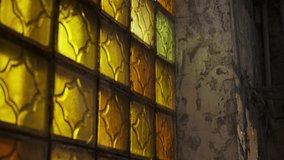 close up view of yellow stained glass windows in abandoned building with concrete walls. Light passes through yellow glass and enters interior of building. - Powered by Shutterstock - Get 15% off with code: PIKWIZARD15