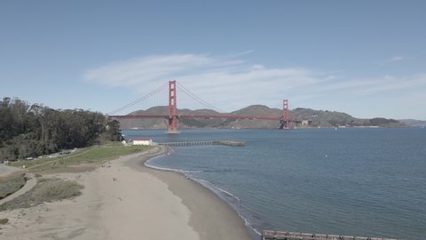 Aerial drone view over San Francisco Golden Gate Beach toward golden gate bridge