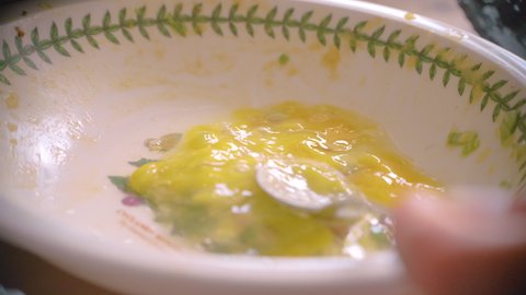 whisking eggs in bowl to cook