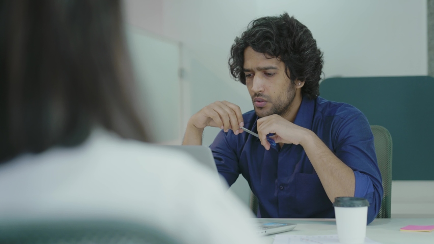 Young indian man manager talking to applicant at job interview asking questions at business meeting, company recruiter employer listening to seeker making hiring decision at employment negotiations.