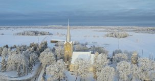 Aerial view of the Church of the Blessed Virgin Mary in Joelahtme (Estonian - Püha Neitsi Maarja kirik, Jõelähtme) on a sunny winter morning. One of the oldest churches in Estonia