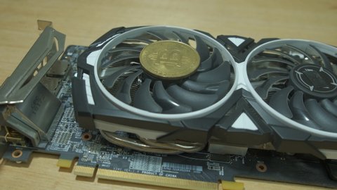 Graphic card with BTC coin and rotating fan Ehtereum Crypto mining rig