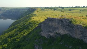 Splendid rocky canyon and green hills on a sunny day. Bird's eye view. Location place Dniester River, Ukraine, Europe. Cinematic drone shot. Filmed in UHD 4k video. Discover the beauty of earth.