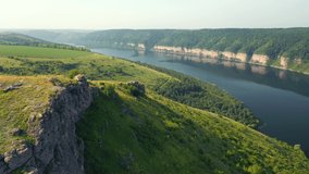 Picturesque view of the grand river and green valley from a bird's eye view. Location place Dniester River, Ukraine, Europe. Cinematic drone shot. Filmed in UHD 4k video. Discover the beauty of earth.