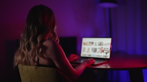 Woman watching porn sites at night.