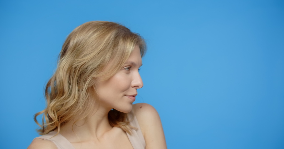 Blonde pretty woman poses in the beauty video on the blue screen. Women's cosmetics usage. Beauty care procedures on blue screen, 4k Prores HQ
