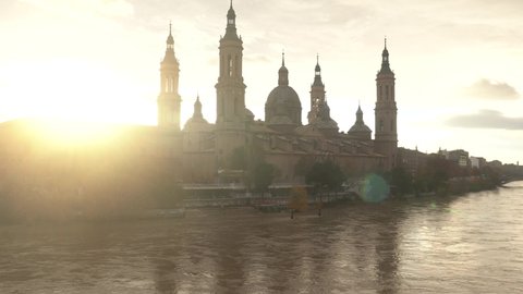 Sunset from the stone bridge next to the Basilica of Nuestra Señora del Pilar over the Ebro river in the city of Zaragoza, Aragon. Spain, 4k video