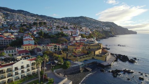 Aerial view the city of Funchal, capital of Madeira, Portugal, flying around the fortress on the coast of Atlantic Ocean in Funchal 