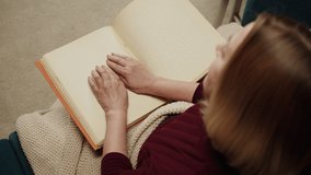Blind woman reading braille book top view, poorly seeing female person learning to read, home education for people with disabilities, touching letters on sheet of paper. - Powered by Shutterstock - Get 15% off with code: PIKWIZARD15