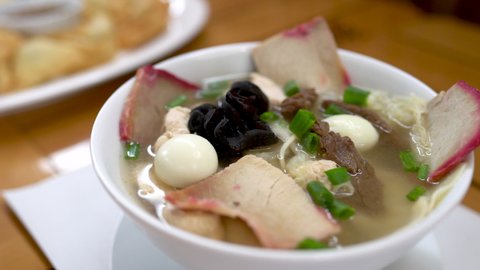 Special wantan soup with chunks of pork, beef, egg and Chinese onion. Peruvian food.