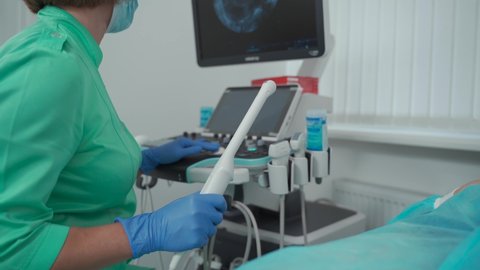 Gynecologist office. Female doctor operating ultrasound scanner. Transvaginal ultrasound scanner of internal organs of pelvis. Female health concept. Diagnostics. Sonography. Obstetrician office