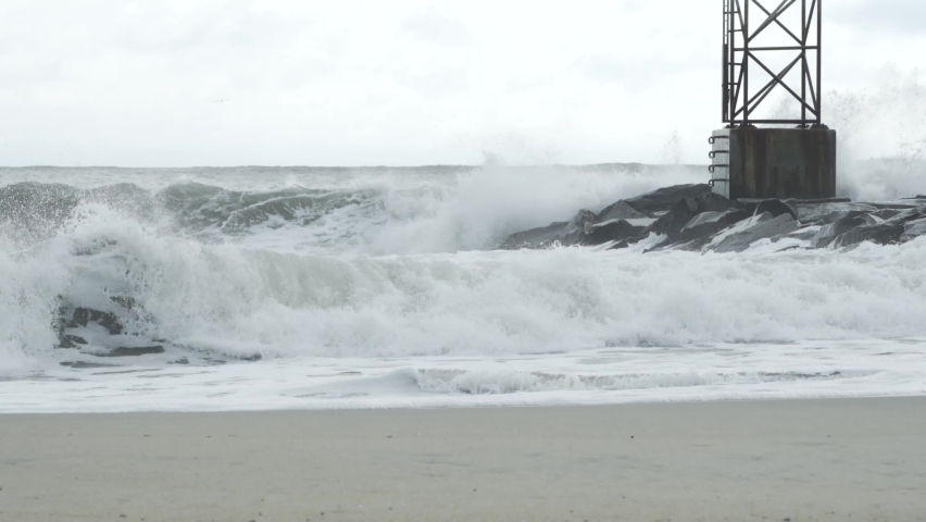 The constant violent churn of the crashing waves on protein rich oxygenated sea water creates a foam on the surface which retreats with the outgoing tides as waves crash on the jetty rocks