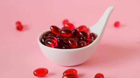 Krill oil  in a white ceramic spoon.omega fatty acids. Flying capsules red krill oil.Natural supplements and vitamin