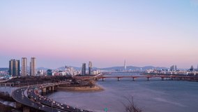 Cityscape view during dusk  overlooking   river with traffic  District in Seoul city at skyline at sunset in South Korea. Dusk to night.