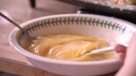 whisking eggs in bowl to cook