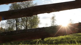 video clip shows a traditional wooden fence and a sunny landscape during summertime
