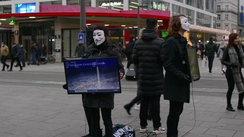 Antwerp, Belgium - December 19, 2021: protesters choosing  the Sunday before Christmas to demonstrate in the main shopping street. Holding in their hands on electronic screen docu chicken farm abuse 