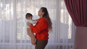 Baby and mom are very happy.
The mother throws the baby in the air and holds it. Then he hugs and loves. This is a Slow motion video.