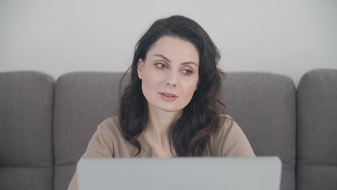 Freelancer writer woman typing text on laptop at home on lockdown. Beautiful brunette woman in late 30s working on notebook computer. Stock video clip of free lance worker female filmed in 4K ultra hd