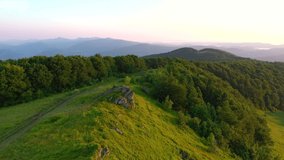 Tourist camp with tents on top of the ridge from a bird's eye view. Location place Carpathian, Ukraine, Europe. Cinematic aerial drone shot. Filmed in UHD 4k video. Discover the beauty of earth.