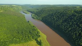 Picturesque view of the grand river and green valley from a bird's eye view. Location place Dniester River, Ukraine, Europe. Cinematic drone shot. Filmed in UHD 4k video. Discover the beauty of earth.