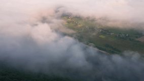 A thick fluffy fog covered the Dniester river valley in the morning. Bird's eye view. Location place Ukraine, Europe. Cinematic drone shot. Filmed in UHD 4k video. Discover the beauty of earth.