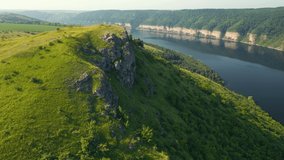 Majestic view of the river canyon and green hills from a bird's eye view. Location Dniester River, Ukraine, Europe. Cinematic drone shot. Filmed in UHD 4k video. Discover the beauty of earth.